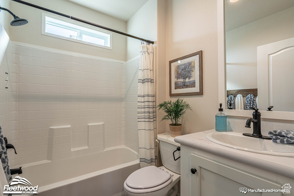 Full bathroom featuring shower / bathtub combination with curtain, toilet, and vanity