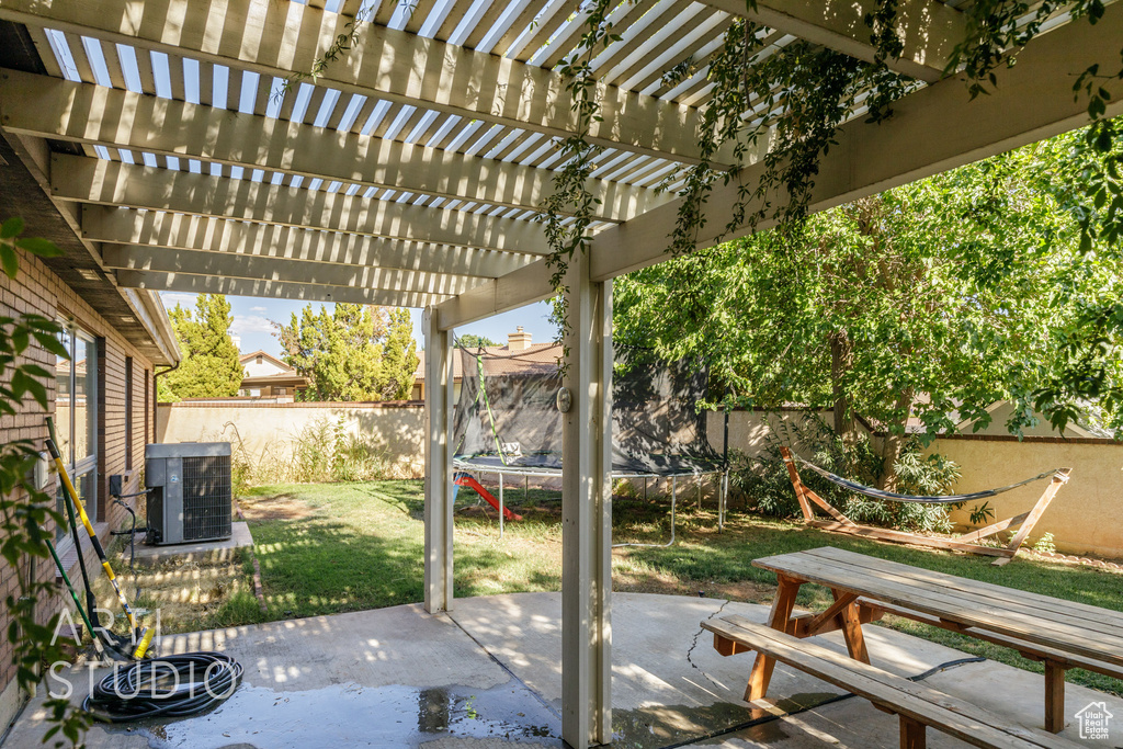 View of patio featuring a pergola, a trampoline, and cooling unit