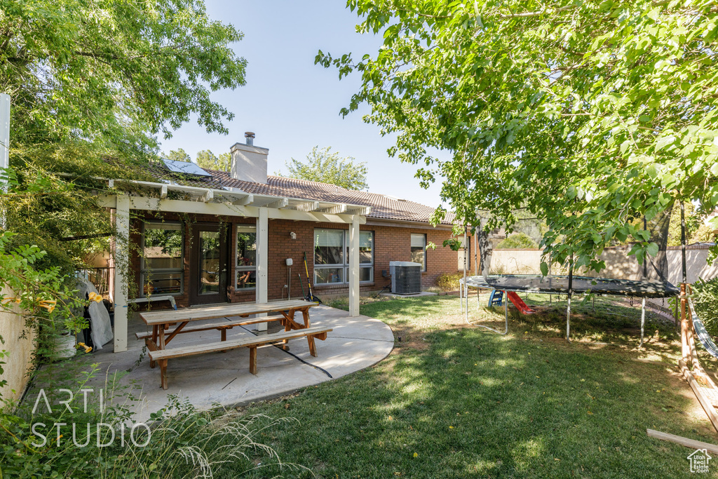 View of yard with central AC and a patio area