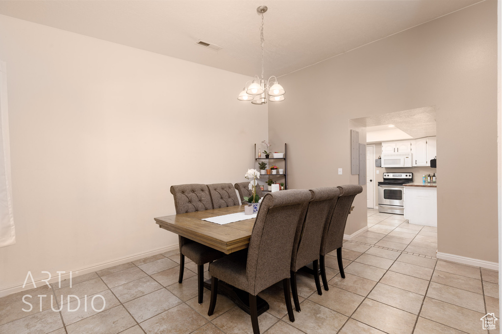 Tiled dining area with an inviting chandelier