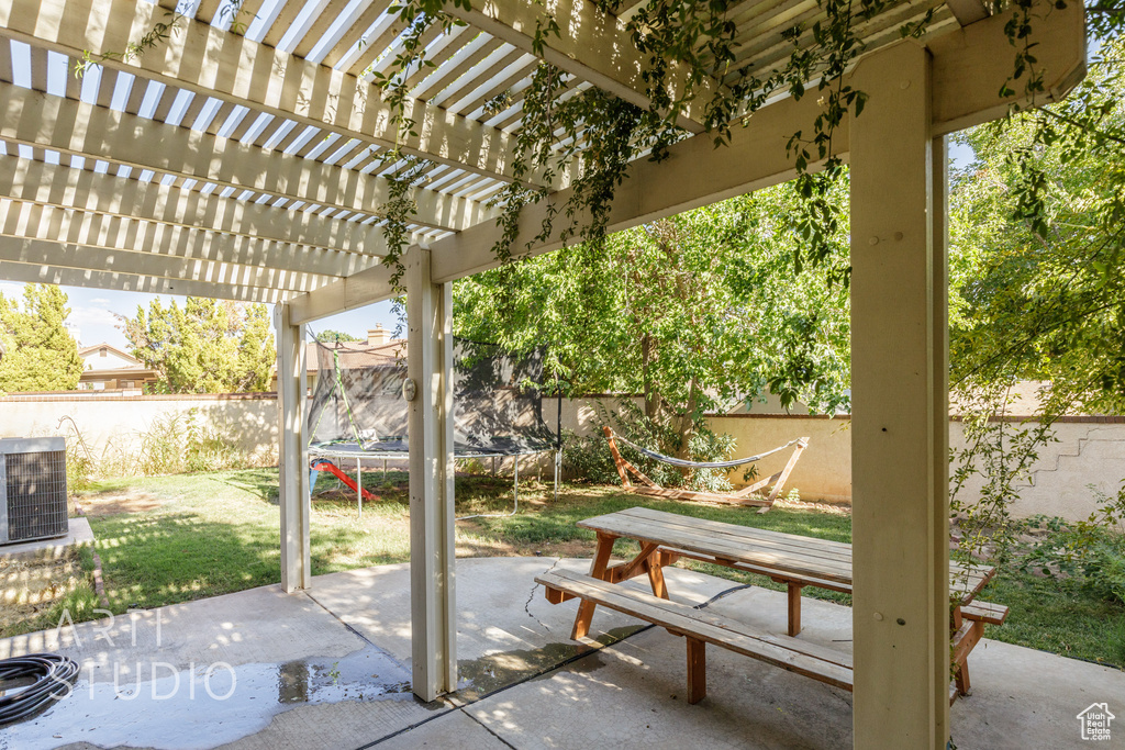 View of patio / terrace with central AC, a pergola, and a trampoline