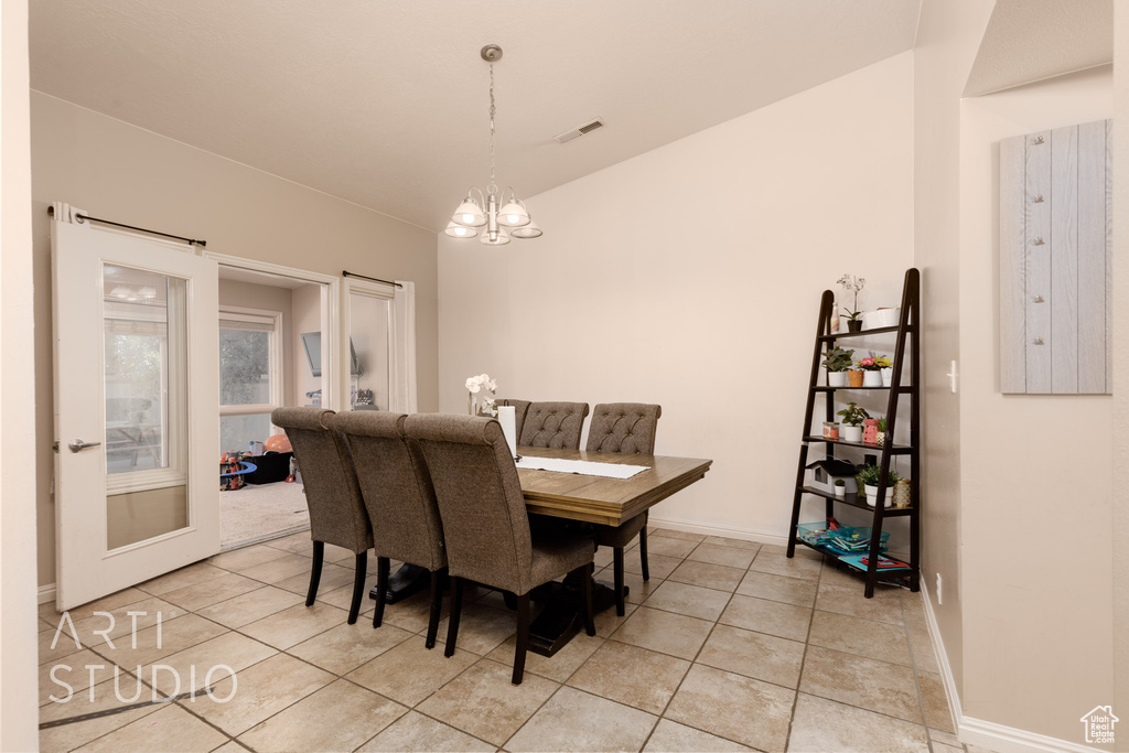 Tiled dining area with a notable chandelier