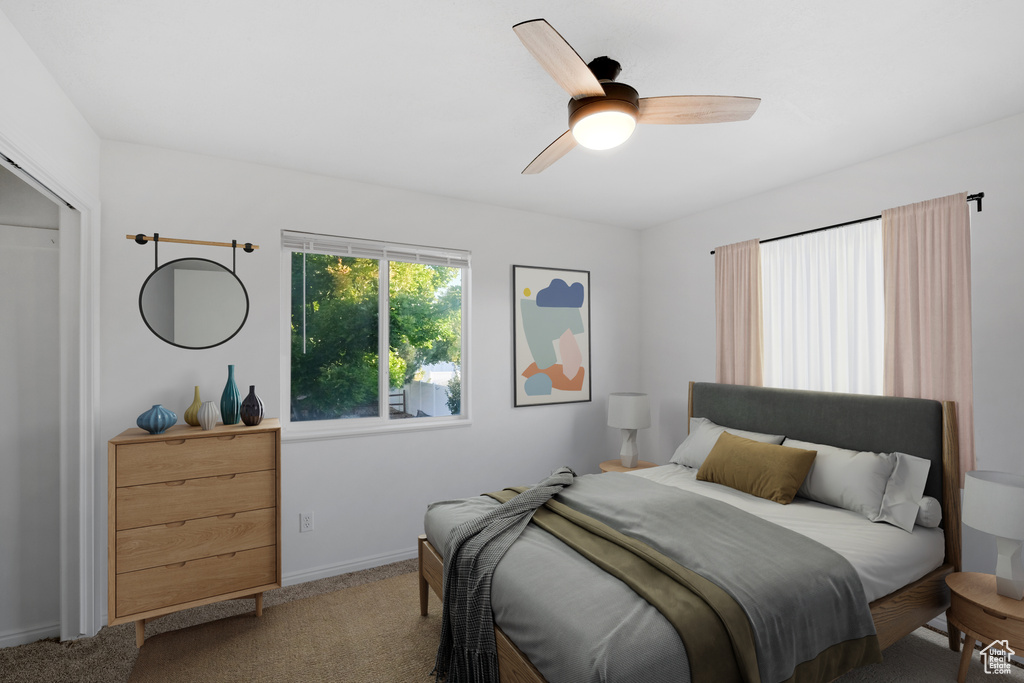 Bedroom featuring ceiling fan and carpet