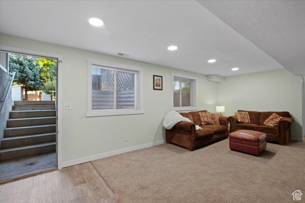 Living room featuring wood-type flooring and plenty of natural light