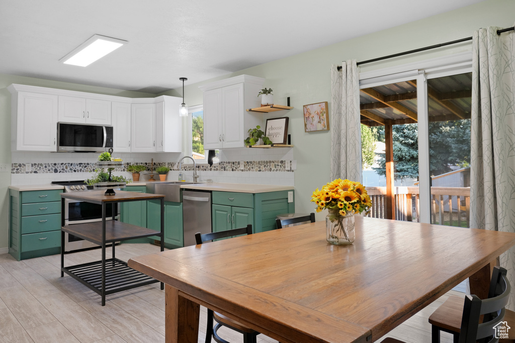 Dining room featuring light hardwood / wood-style floors, sink, and a wealth of natural light