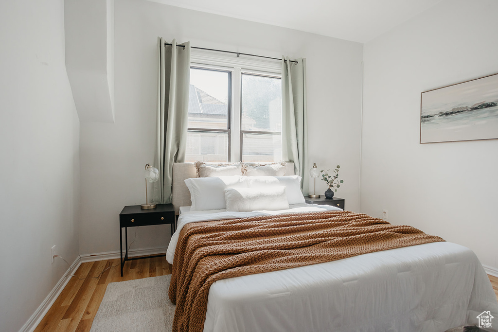 Bedroom with light hardwood / wood-style flooring