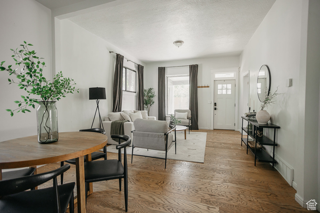 Foyer entrance featuring light hardwood / wood-style flooring and a textured ceiling