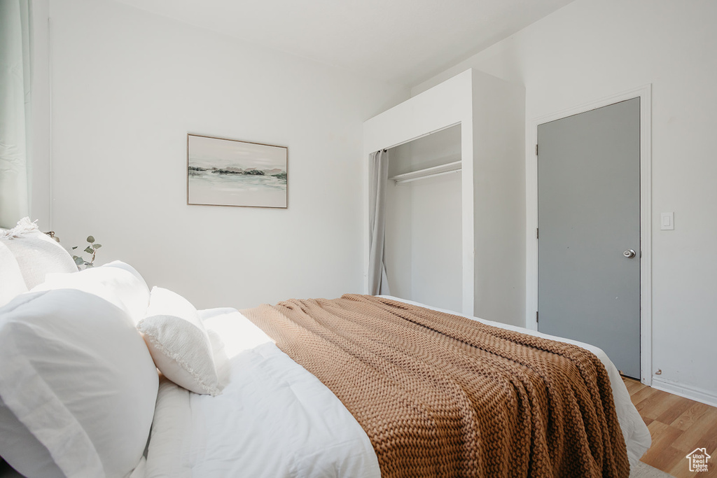 Bedroom featuring light wood-type flooring and a closet