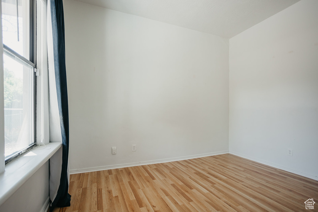 Unfurnished room featuring plenty of natural light and light hardwood / wood-style floors