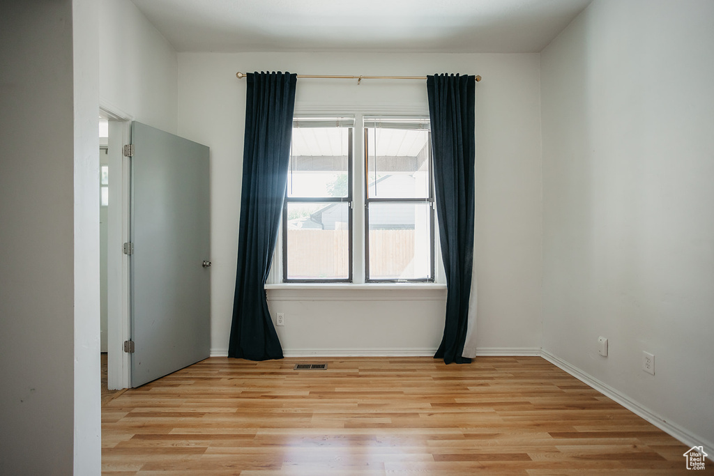 Unfurnished room featuring plenty of natural light and light hardwood / wood-style floors