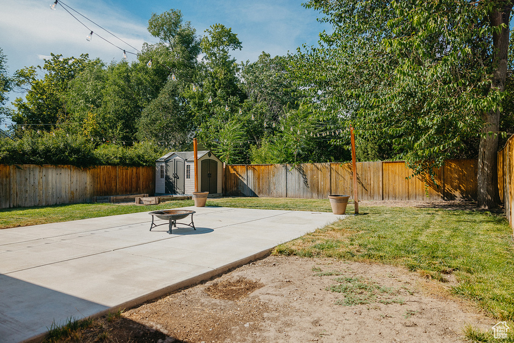 View of yard with a shed and a patio