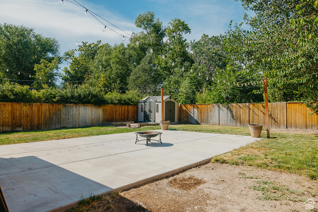 View of patio featuring a storage shed