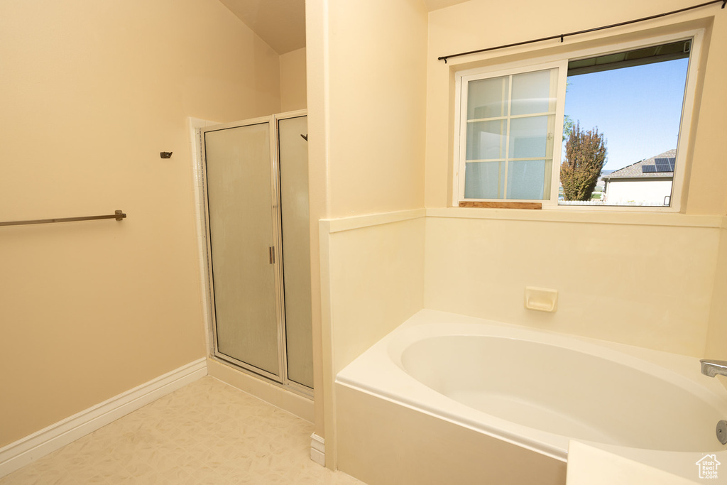 Bathroom with plus walk in shower and tile patterned floors