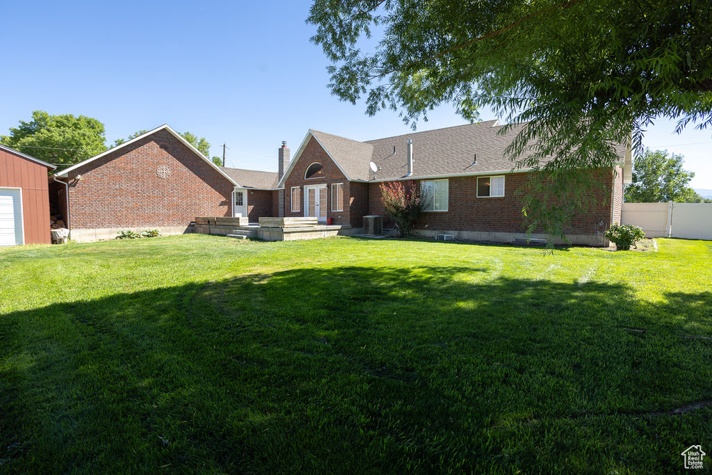 Rear view of house with a lawn