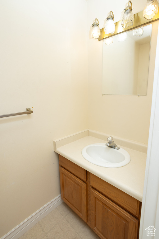 Bathroom with tile patterned flooring and vanity