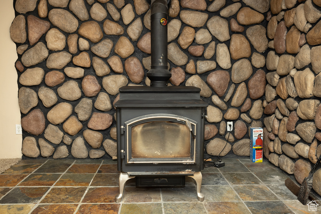 Details with tile patterned floors and a wood stove