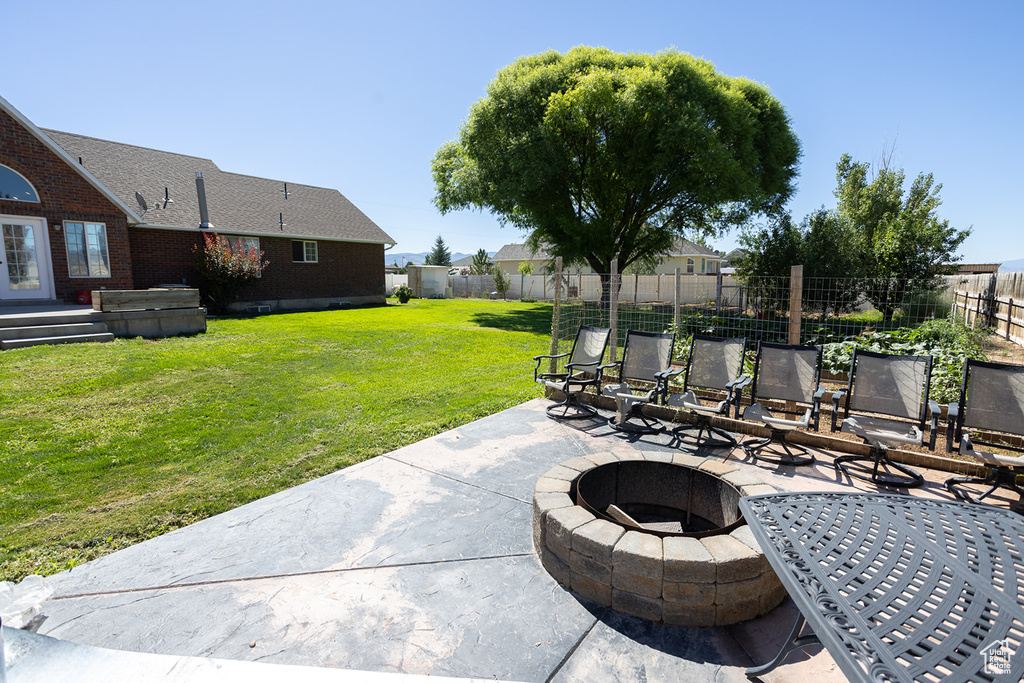 View of patio / terrace featuring an outdoor fire pit