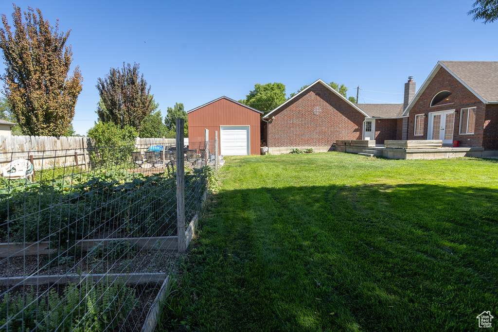 View of yard with an outdoor structure and a garage