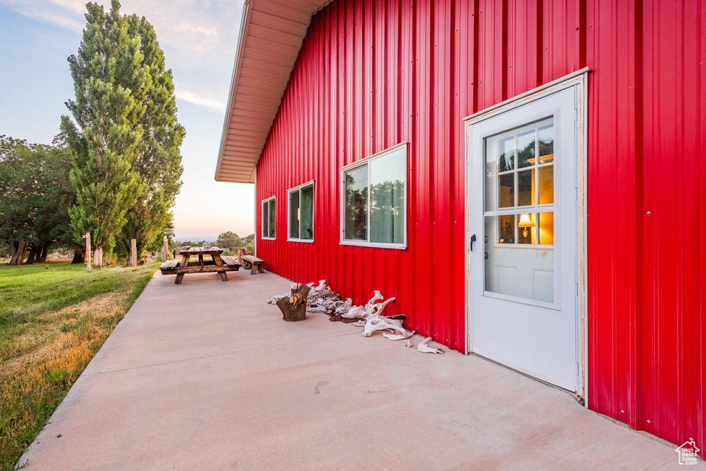 Exterior entry at dusk with a lawn