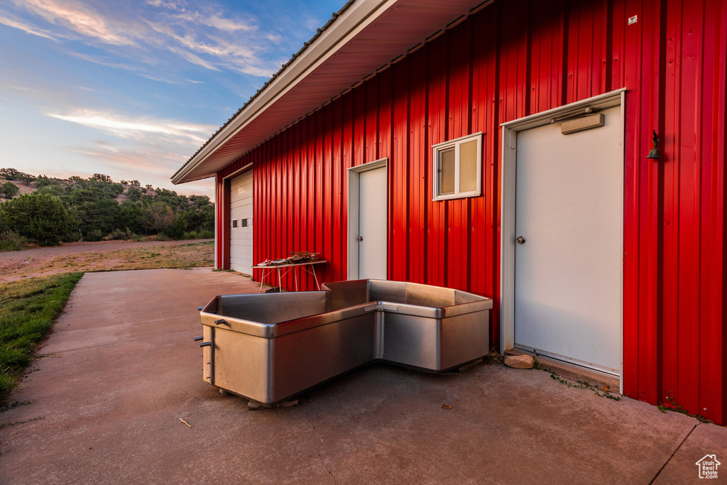 Patio terrace at dusk with a garage