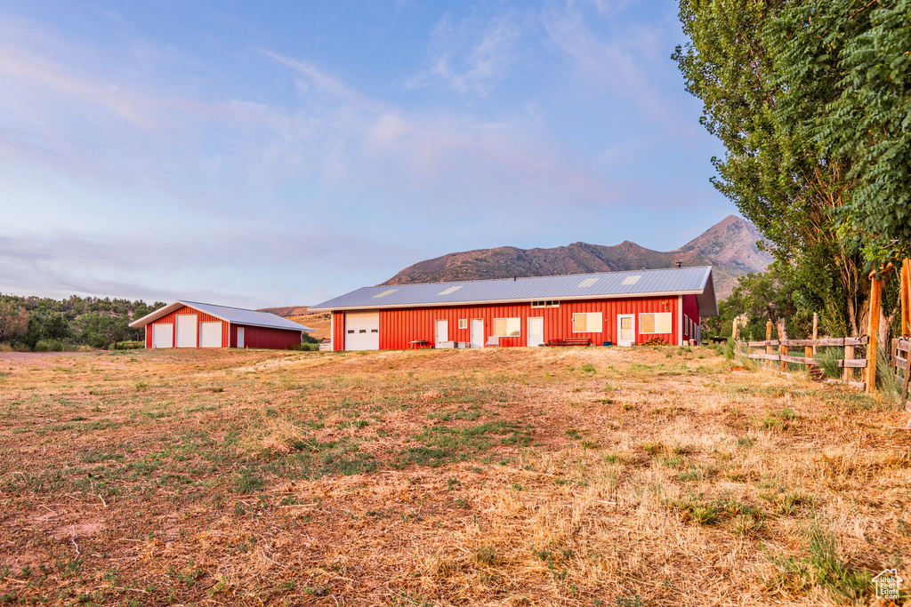 Rear view of property featuring a mountain view, an outbuilding, and a garage