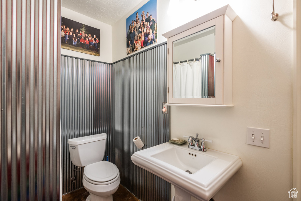 Bathroom featuring sink and toilet