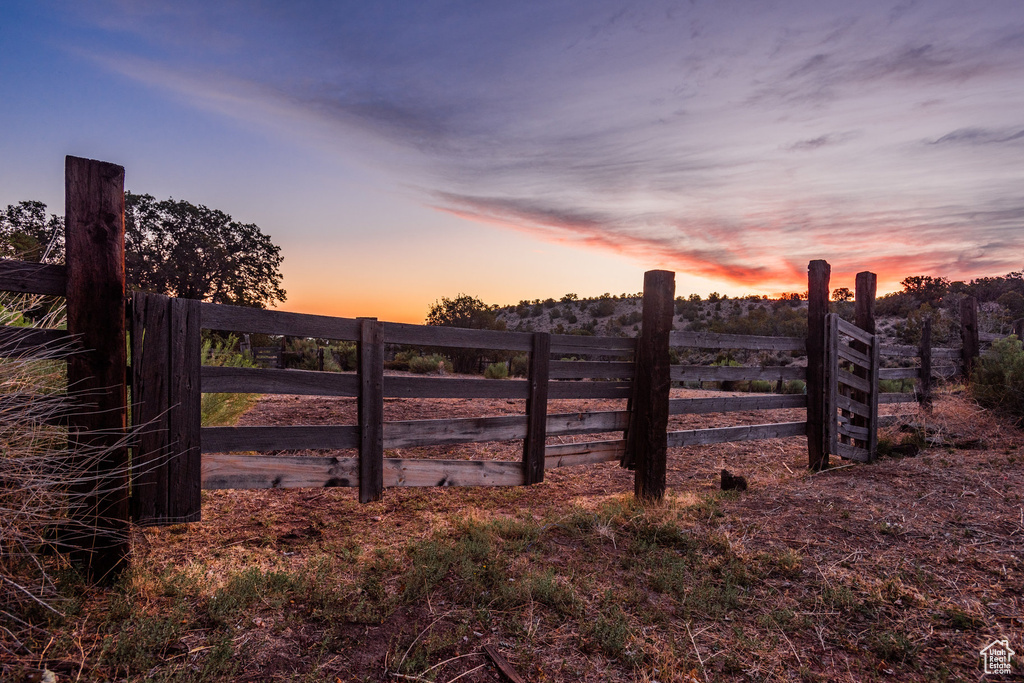 Gate at dusk with a rural view