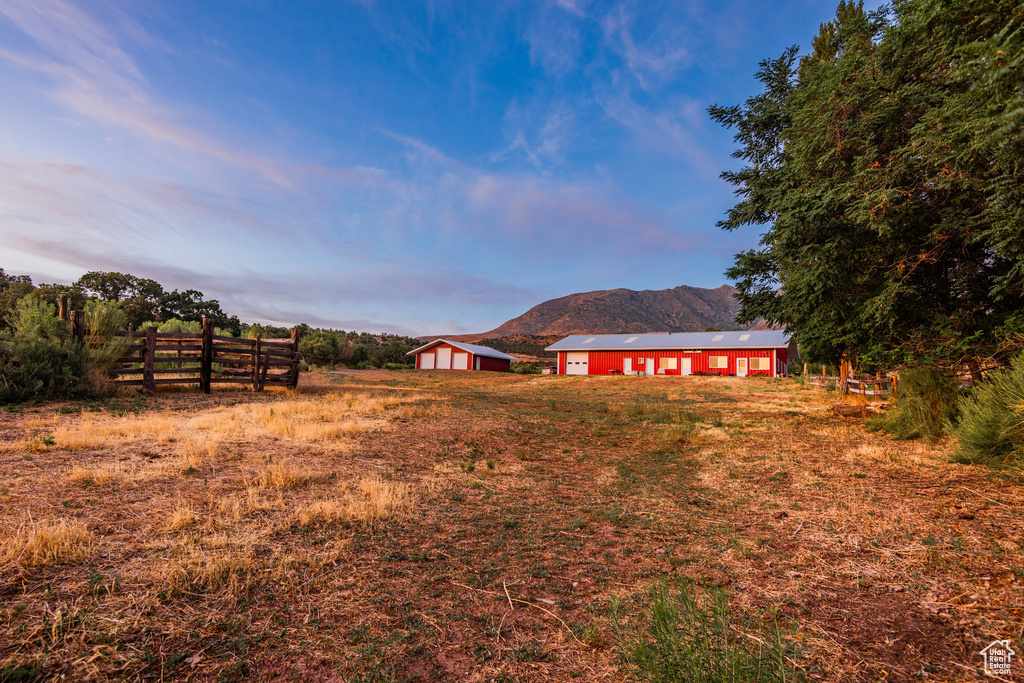 View of yard with a rural view and a mountain view