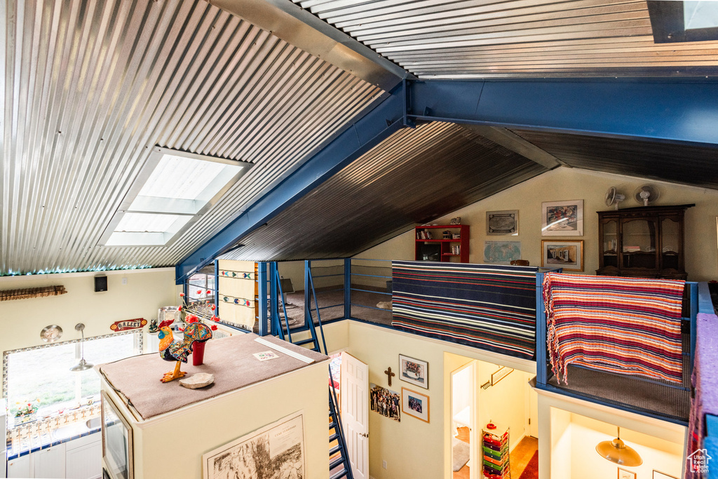 Additional living space with lofted ceiling with skylight