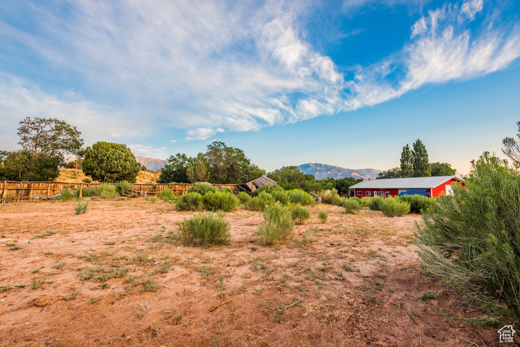 View of yard with a rural view and a mountain view