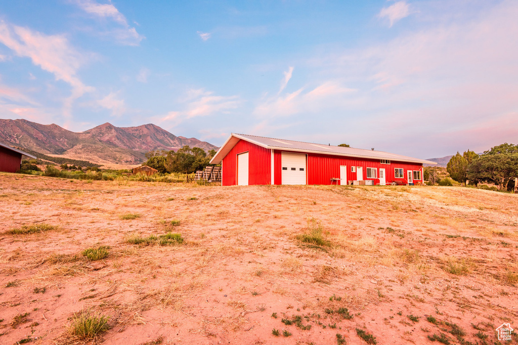 View of outbuilding featuring a mountain view and a garage