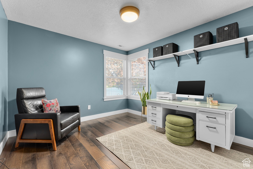 Office with hardwood / wood-style flooring and a textured ceiling