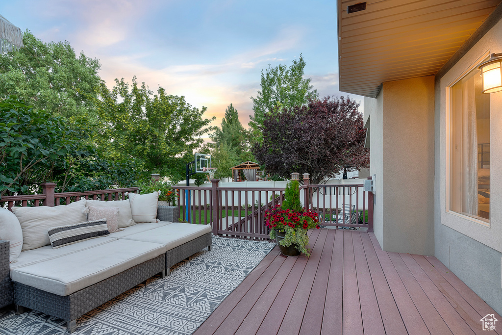 Deck at dusk featuring an outdoor living space