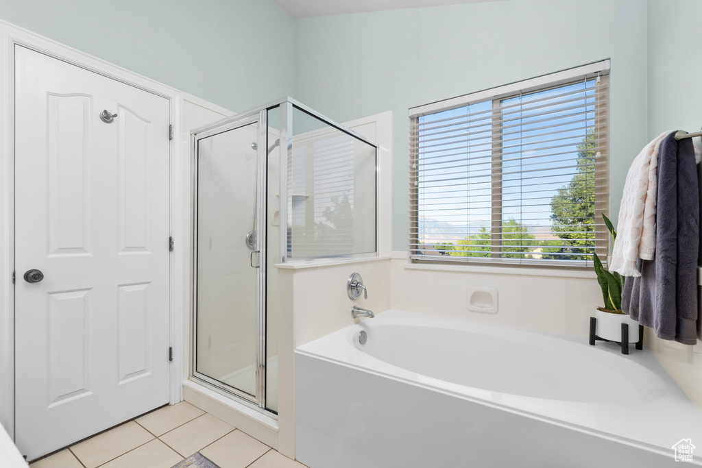 Bathroom with separate shower and tub and tile patterned flooring