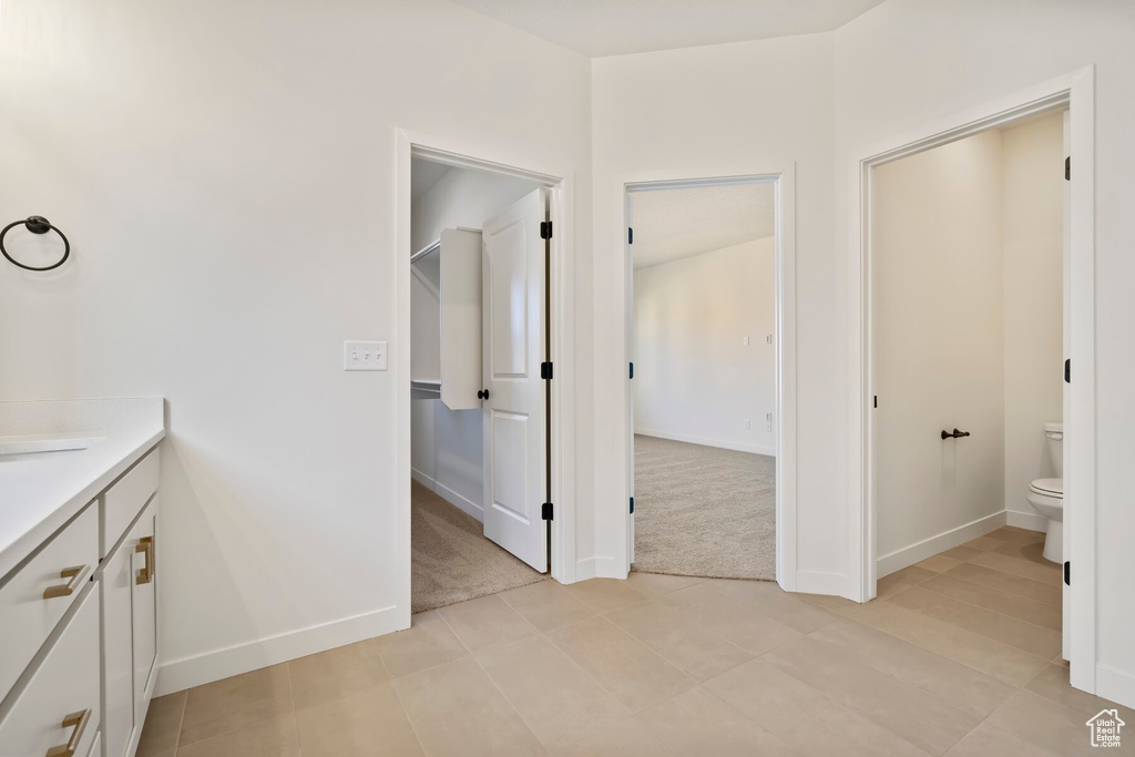 Bathroom with toilet, baseboards, and vanity