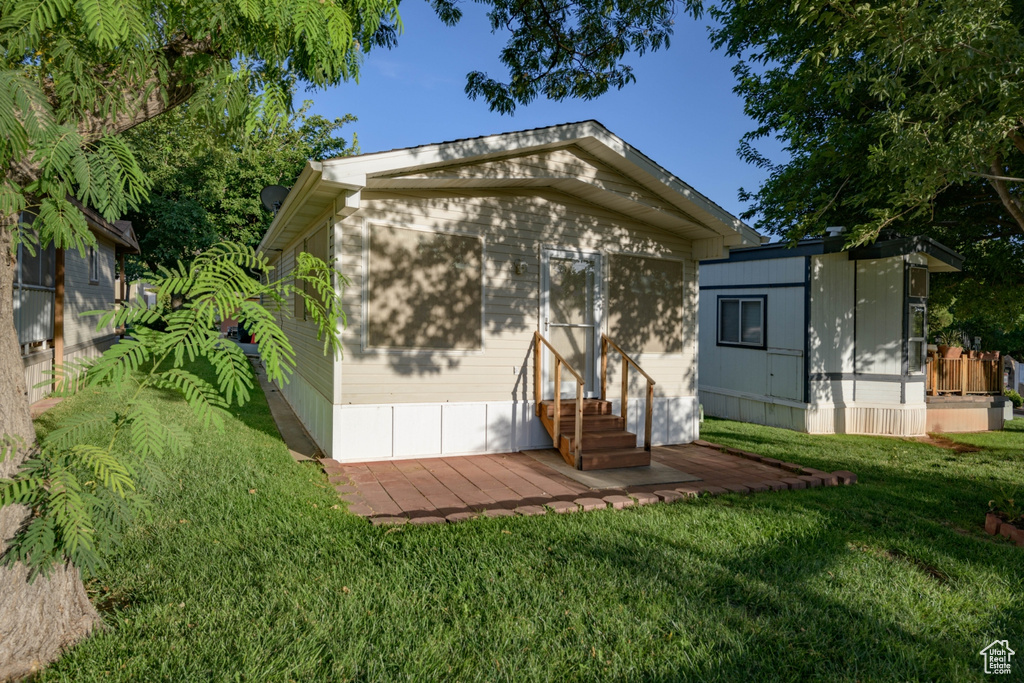 View of outbuilding with a lawn