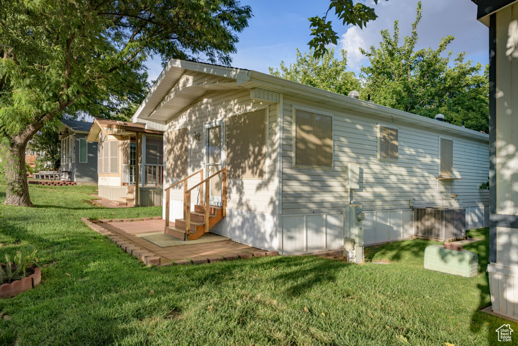 View of side of property featuring a yard