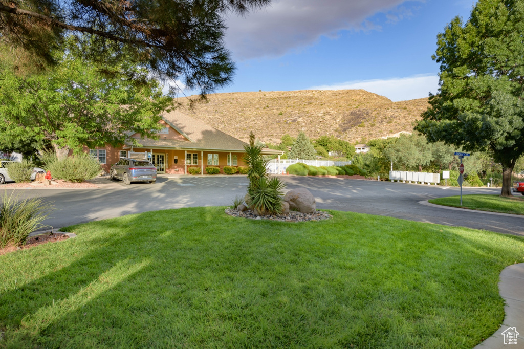 View of front of property featuring a mountain view and a front yard