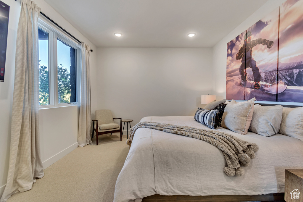 Bedroom with light colored carpet