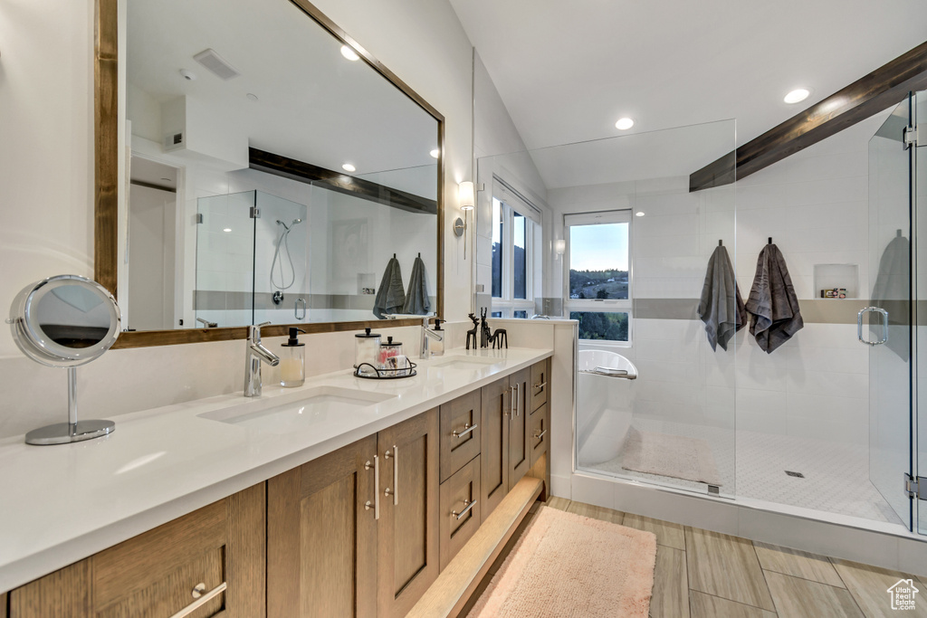 Bathroom with tile patterned flooring, double sink vanity, and an enclosed shower