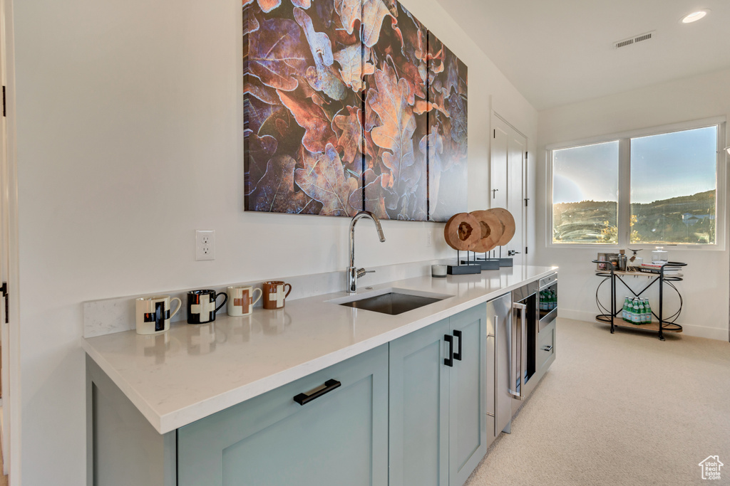 Bar featuring sink and light carpet