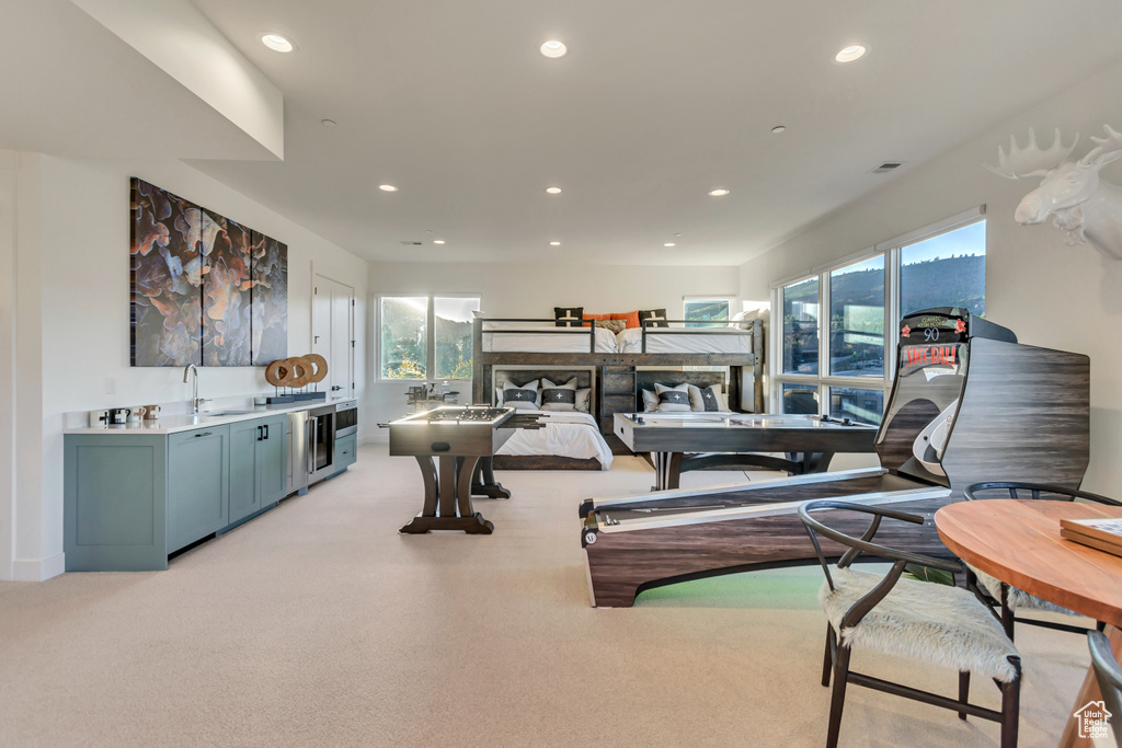 Gym with sink and light colored carpet