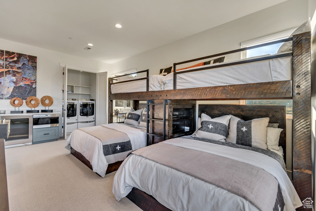 Bedroom with carpet flooring and washing machine and dryer