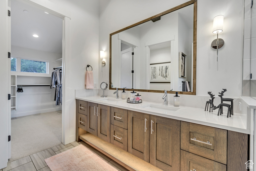 Bathroom with dual bowl vanity and tile patterned floors