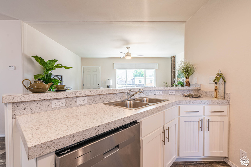 Kitchen featuring white cabinetry, stainless steel dishwasher, sink, kitchen peninsula, and ceiling fan