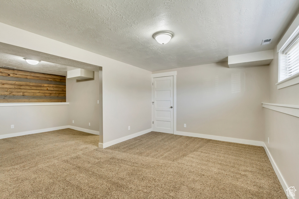 Interior space with carpet floors and a textured ceiling