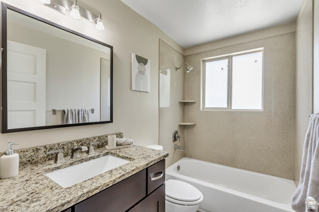 Full bathroom featuring shower / washtub combination, vanity, and toilet