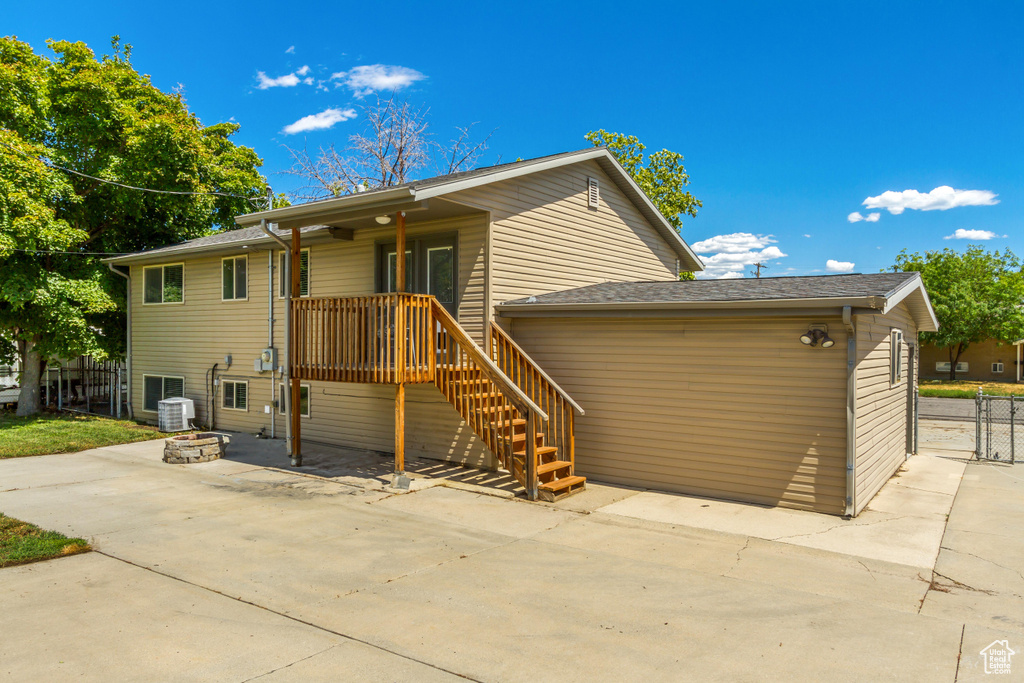 View of front of property featuring a patio and central AC