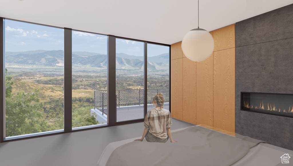 Unfurnished bedroom with a mountain view and a tiled fireplace