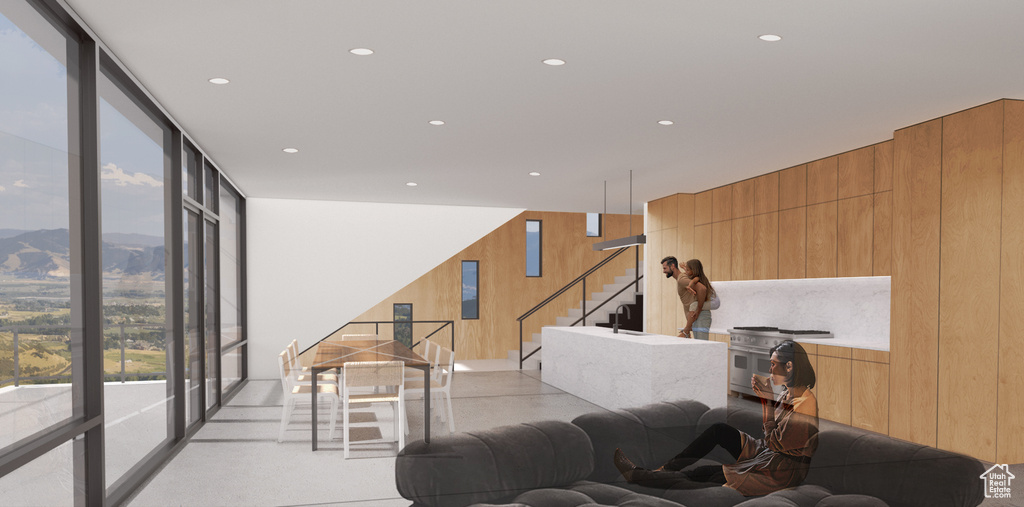 Living room featuring wood walls, a mountain view, and expansive windows